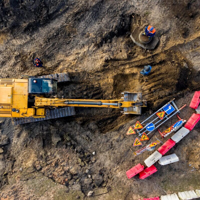 Overhead view of an excavator digging in the dirt